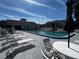 Community pool with lounge chairs and seating areas at 12027 Hoosier Ct # 104, Hudson, FL 34667