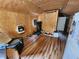 Living room featuring wood paneled walls and ceiling with vinyl floors and a recliner chair at 12035 Ipswich Sparrow Rd, Weeki Wachee, FL 34614