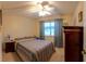 Cozy bedroom featuring a ceiling fan, and a window with patterned curtains at 12400 Eagleswood Dr # A, Hudson, FL 34667