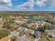 Picturesque aerial view of a charming neighborhood adjacent to a lake and golf course at 13032 Pinnacle Ln, Hudson, FL 34669