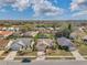 An aerial view of the home and neighborhood, highlighting its well-maintained lawns and proximity to local amenities at 13032 Pinnacle Ln, Hudson, FL 34669