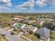 An aerial view of the neighborhood showcasing the residential homes, lawns, and landscaping at 13032 Pinnacle Ln, Hudson, FL 34669