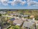 An aerial view of the neighborhood showcasing the residential homes, lawns, and a peaceful lake at 13032 Pinnacle Ln, Hudson, FL 34669