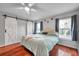 Charming bedroom features barn-style closet doors, hardwood floors, and natural lighting at 13032 Pinnacle Ln, Hudson, FL 34669