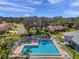 Aerial view of a luxurious community pool area with ample seating and beautifully landscaped surroundings at 13032 Pinnacle Ln, Hudson, FL 34669