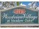 Welcome to Woodview Village at Meadow Oaks, a deed-restricted community sign at 13032 Pinnacle Ln, Hudson, FL 34669