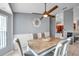 Comfortable dining area shows light gray walls, stylish table set, and pendant fan at 13032 Pinnacle Ln, Hudson, FL 34669