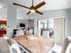 Dining room boasts a wood table, neutral-toned chairs, and an modern ceiling fan at 13032 Pinnacle Ln, Hudson, FL 34669