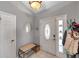 Inviting entryway featuring neutral paint, tile floors, and a decorative mirror at 13032 Pinnacle Ln, Hudson, FL 34669
