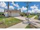 Inviting home featuring a well-manicured lawn and a spacious driveway at 13032 Pinnacle Ln, Hudson, FL 34669
