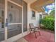 Cozy front porch with a screen door and a charming seating area at 13032 Pinnacle Ln, Hudson, FL 34669