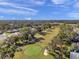 Scenic aerial shot of the golf course featuring well-maintained greens, sand traps, and surrounding trees at 13032 Pinnacle Ln, Hudson, FL 34669