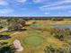 An aerial view of golf course with lush fairways, sand traps, and scenic views at 13032 Pinnacle Ln, Hudson, FL 34669