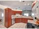 Well-lit kitchen features warm-toned cabinets, light countertops, and modern appliances at 13032 Pinnacle Ln, Hudson, FL 34669