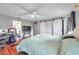 Spacious main bedroom with a ceiling fan, barn doors, and ensuite bathroom access at 13032 Pinnacle Ln, Hudson, FL 34669