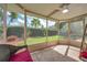 Sunny screened patio with comfortable seating and a beautiful backyard view, perfect for outdoor relaxation and entertainment at 13032 Pinnacle Ln, Hudson, FL 34669