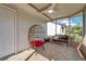 Inviting sunroom with tile flooring, a ceiling fan and comfortable seating, perfect for relaxation and enjoying the outdoors at 13032 Pinnacle Ln, Hudson, FL 34669