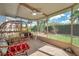 Bright sunroom with tile floors, comfortable seating, and lush backyard views, creating a serene and inviting atmosphere at 13032 Pinnacle Ln, Hudson, FL 34669