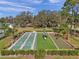 Outdoor shuffleboard courts offering a fun recreational activity amidst landscaped grounds and mature trees at 13032 Pinnacle Ln, Hudson, FL 34669
