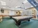Recreational billiard room with pool tables, bar stools, and a green carpet at 1320 Wolford Dr, Trinity, FL 34655