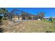 Image shows the back of the home with a fenced in pool at 1414 Grand Blvd, Holiday, FL 34690