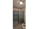 Bathroom with shower featuring blue tile and a sliding glass door at 1414 Grand Blvd, Holiday, FL 34690