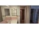 Pink bathroom featuring tub with shower curtain and built in storage at 1414 Grand Blvd, Holiday, FL 34690