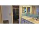 Bathroom featuring a vanity with a white countertop and a shower with sliding glass doors at 1414 Grand Blvd, Holiday, FL 34690