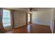 Bedroom with hardwood floors, ceiling fan, two windows and view of water at 1414 Grand Blvd, Holiday, FL 34690