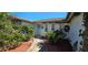 Close-up of the entrance, showing walkway and plants at 1414 Grand Blvd, Holiday, FL 34690