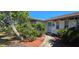 Close-up of the entrance, showing walkway and plants at 1414 Grand Blvd, Holiday, FL 34690