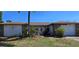 Charming single-story home featuring stone accents, lush landscaping, and a well-maintained front yard at 1414 Grand Blvd, Holiday, FL 34690
