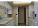 Bright kitchen featuring a sink, dishwasher, and tile floor at 1414 Grand Blvd, Holiday, FL 34690