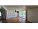 Living room featuring wood floors and sliding glass doors to outdoor area at 1414 Grand Blvd, Holiday, FL 34690