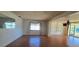 Living room with wood flooring, large windows, and ample natural light at 1414 Grand Blvd, Holiday, FL 34690