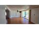 Living room with wood flooring and sliding glass doors to a patio at 1414 Grand Blvd, Holiday, FL 34690