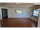 Living room featuring wood flooring, a window, and an open floor plan at 1414 Grand Blvd, Holiday, FL 34690