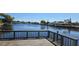 Scenic water view from a wooden deck, showcasing waterfront living and community at 1414 Grand Blvd, Holiday, FL 34690