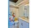 Bright bathroom featuring a marble countertop, decorative shower curtain, and modern vanity lighting at 2843 Thaxton Dr # 34, Palm Harbor, FL 34684