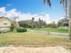 View of the front yard with a well-maintained lawn and mature trees at 2843 Thaxton Dr # 34, Palm Harbor, FL 34684