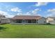 Expansive backyard featuring a screened-in lanai, perfect for outdoor living and entertaining at 3606 Dow Ln, Spring Hill, FL 34609