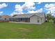 This home features a screened-in patio and a spacious backyard for outdoor enjoyment at 3606 Dow Ln, Spring Hill, FL 34609