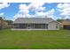 This home features a screened-in patio and a spacious backyard for outdoor enjoyment at 3606 Dow Ln, Spring Hill, FL 34609