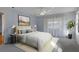 Bedroom featuring a light blue wall, and a king-size bed with decorative pillows and white bedding at 3606 Dow Ln, Spring Hill, FL 34609