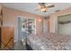 Bedroom featuring a bed, closet doors, sliding glass doors to outdoor patio and ceiling fan at 3606 Dow Ln, Spring Hill, FL 34609