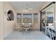 Sunny breakfast nook with bay windows and sliding glass doors to the outside at 3606 Dow Ln, Spring Hill, FL 34609