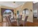 Inviting dining area with a glass table, comfortable seating, and natural light from the window at 3606 Dow Ln, Spring Hill, FL 34609