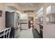 Well-lit kitchen with white cabinets, stainless steel appliances, and an open view to the dining room at 3606 Dow Ln, Spring Hill, FL 34609