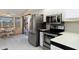 Contemporary kitchen with stainless steel appliances, white countertops, and breakfast nook in the background at 3606 Dow Ln, Spring Hill, FL 34609