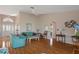 Spacious living room with wood floors, a ceiling fan, and comfortable seating, perfect for Gathering gatherings at 3606 Dow Ln, Spring Hill, FL 34609